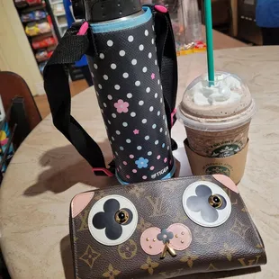 a cup of coffee and a purse