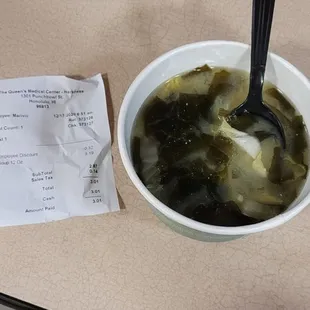 a bowl of soup and a receipt
