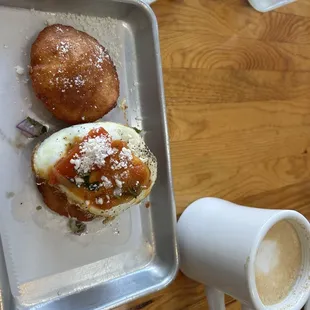 Egg &amp; cheese arepa with kielbasa sausage paired with a cafe con leche