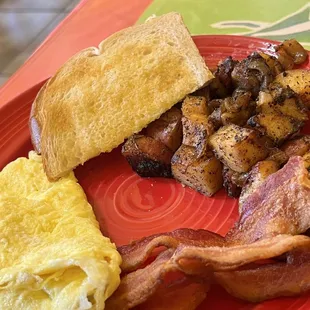 bacon, eggs, and toast on a red plate