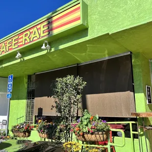 a bright green building with a sign that says cafe rae