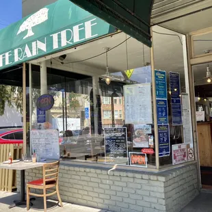 a man standing outside of a restaurant