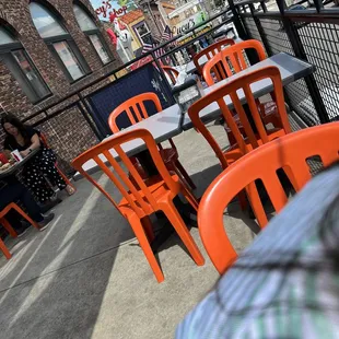 tables and chairs on a sidewalk