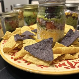 a plate of tortilla chips and a jar of salsa