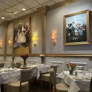 a dining room with white tablecloths and white tablecloths