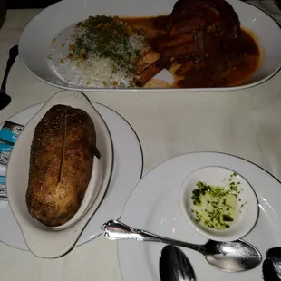 Long shot of the lamb shank and baked potato