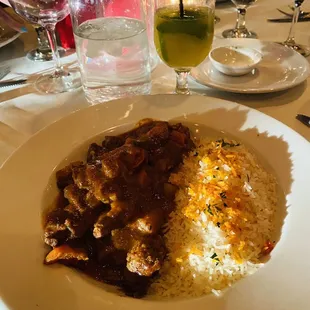Moroccan Tagine-lamb with spice stew of onions, tomatoes, green chilies and potatoes served with saffron basmati rice