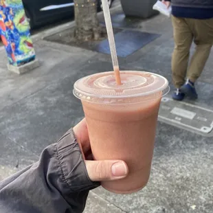 a hand holding a cup of coffee