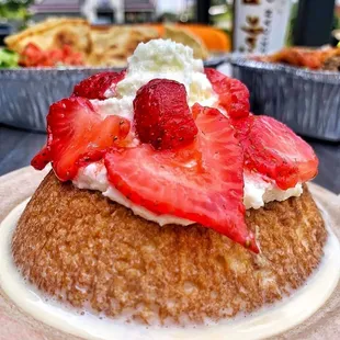 a desert with strawberries and whipped cream