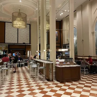 people sitting at tables in a restaurant