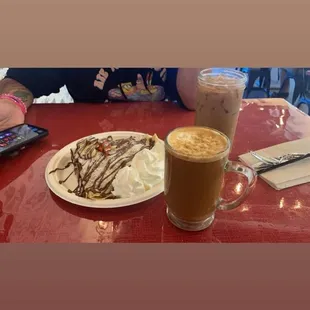 Hot mazapán latte with oat milk along with a Nutella crepe with strawberry and banana on top.