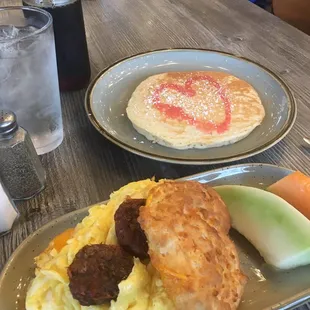 Big biscuit egg sandwich and side pancake