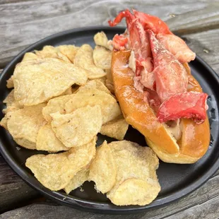 Lobster Roll + Chips w/ roasted garlic + truffle aioli, melted butter, house spice blend, lightly toasted split top bun $27