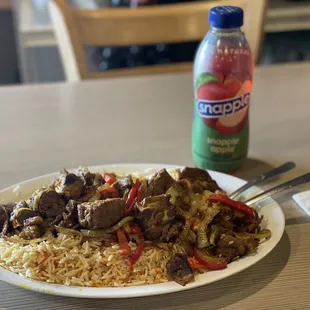 a plate of food and a bottle of soda