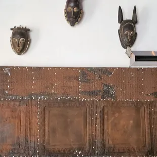 a group of masks mounted on a wall