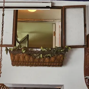 a mirror and hanging planters
