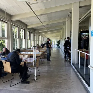 people sitting at tables in a cafeteria