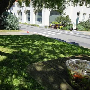 Enter down the sidewalk right infront of that guy, cafe is inside this building. Not much parking.