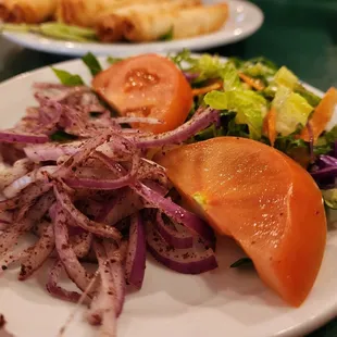 a plate of salad and bread