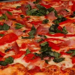 a pizza with tomatoes and basil