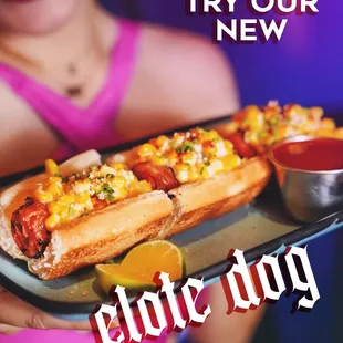 :  
Bacon wrapped hot dog topped with Mexican elote