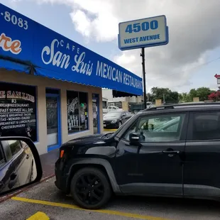a jeep parked in front of a store
