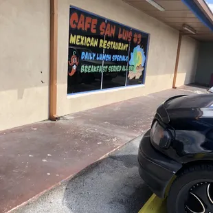 a car parked in front of a restaurant