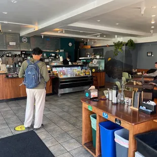 a man standing in a coffee shop