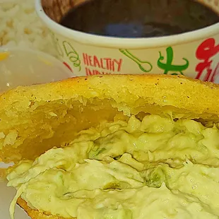 a half eaten sandwich and a cup of coffee