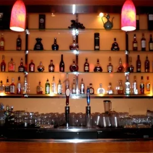 a bar with a lot of bottles on the shelves