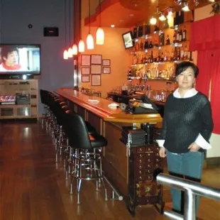 a woman sitting at a bar