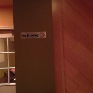 a no smoking sign on a door