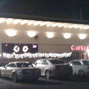 two cars parked in front of a restaurant