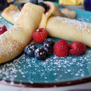 Pannekaker - 2 Norwegian pancakes w/cinnamon and sugar w/preserves - close-up. They are like crepes. Yum. 3.5.22