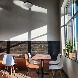 a table and chairs in front of a window