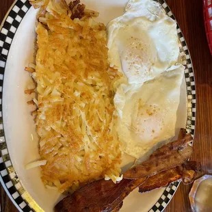 Two over easy eggs with homefries, bacon, and a side of whole wheat buttered toast (not pictured)
