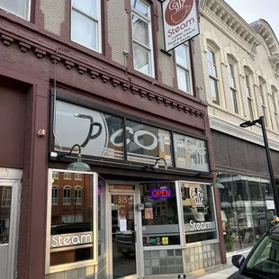 a car parked in front of a coffee shop