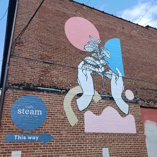 a brick building with a mural on the side