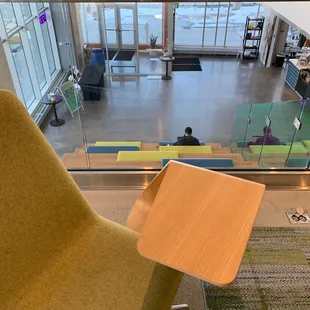 Cafe steam on bottom right and additional seating inside the building.