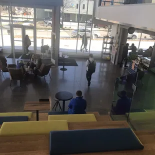 Looking down from the theater-style seating area. To the right is the ordering area. There is a shelf full of board games you can borrow.