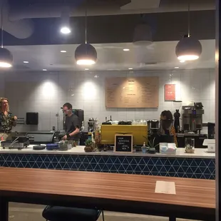 two people preparing food in a kitchen
