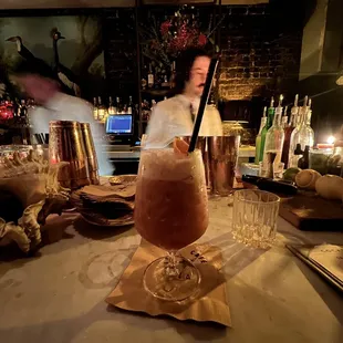 a bartender preparing a drink at a bar