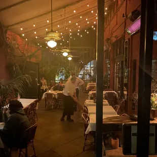 people sitting at tables in a restaurant