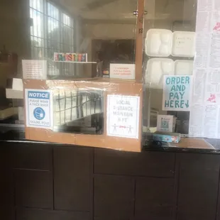 a counter with a sign on it