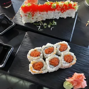 two plates of sushi and a glass of wine