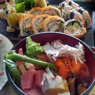 a plate of sushi and a bowl of vegetables