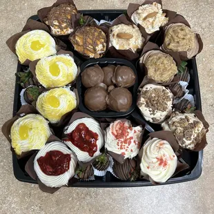 Gourmet cupcake tray with peanut butter balls and chocolate dipped berries.