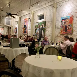 people sitting at tables in a restaurant