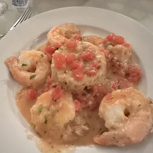 a plate of shrimp with tomato sauce