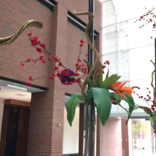 a tall vase with flowers in it